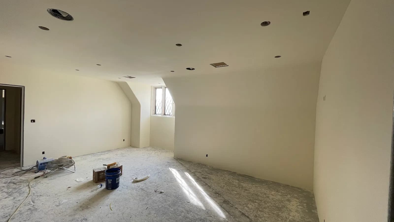Skim-coated walls drying in a whole-house renovation