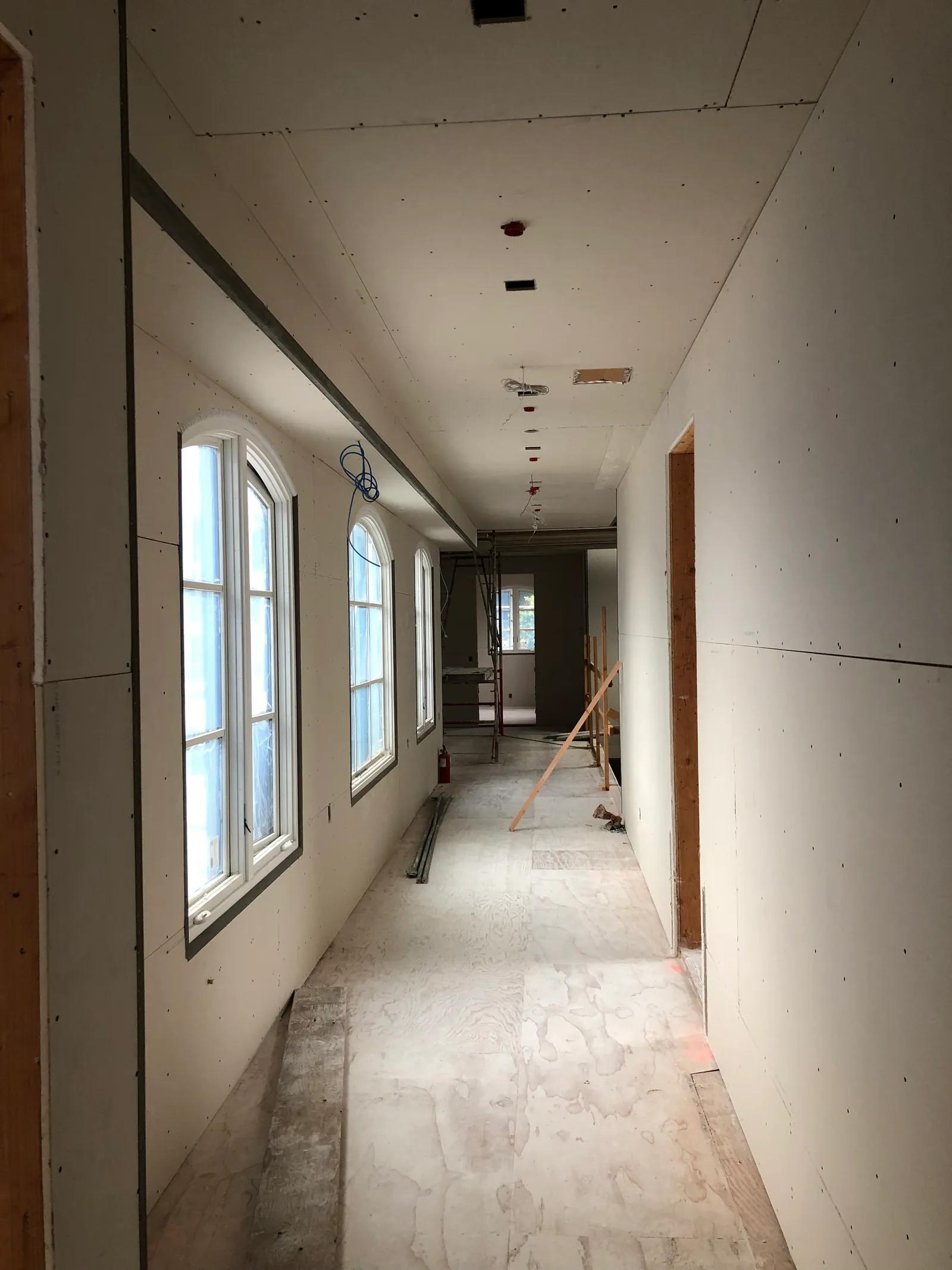 Long gallery corridor hung around exposed timber