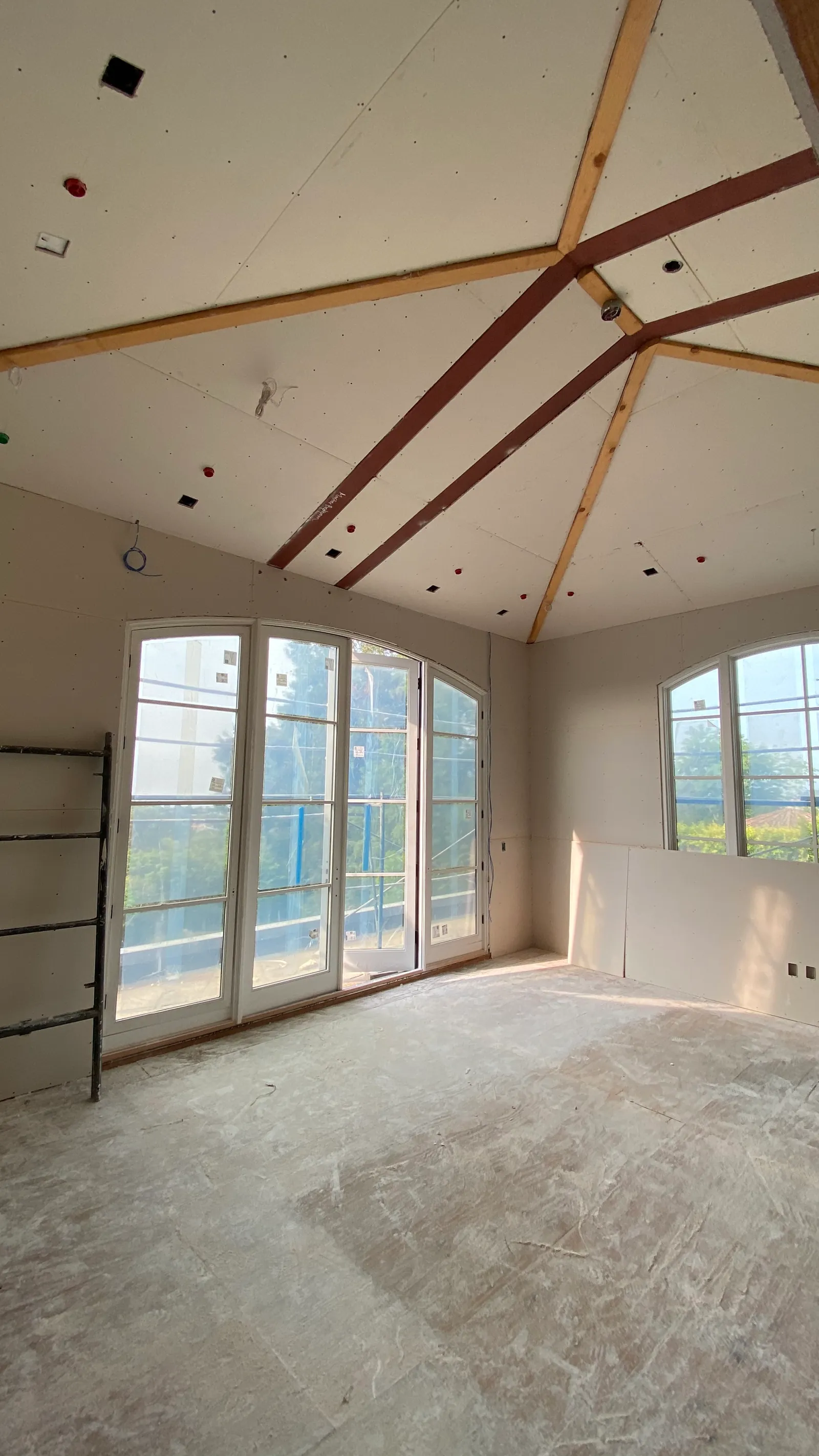 Board hung between exposed trusses